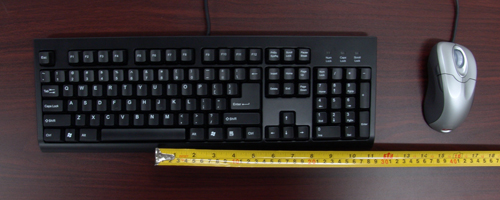 Conventional Keyboard Showing Reach for
              Mouse Due To Asymmetric Design